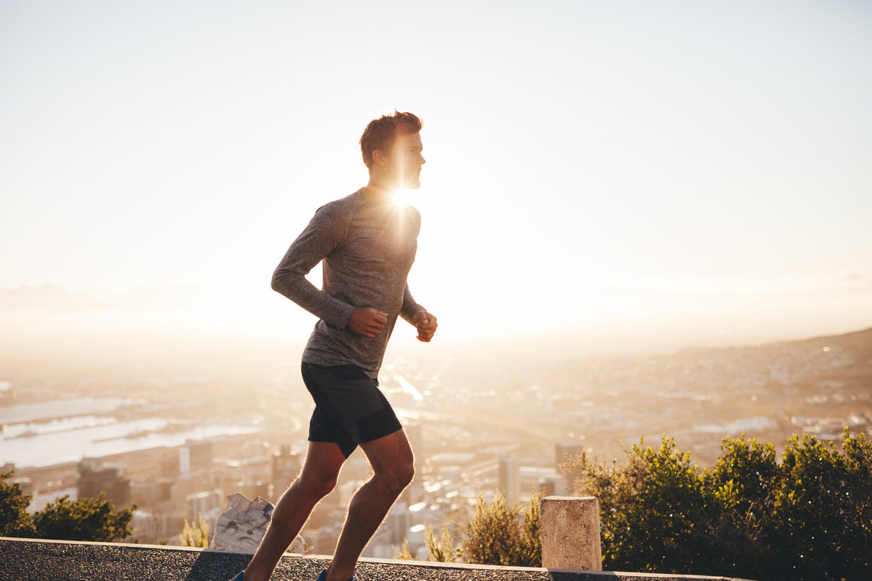 Man running outdoors at sunset